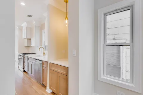 a kitchen with stainless steel appliances granite countertop a stove and a refrigerator