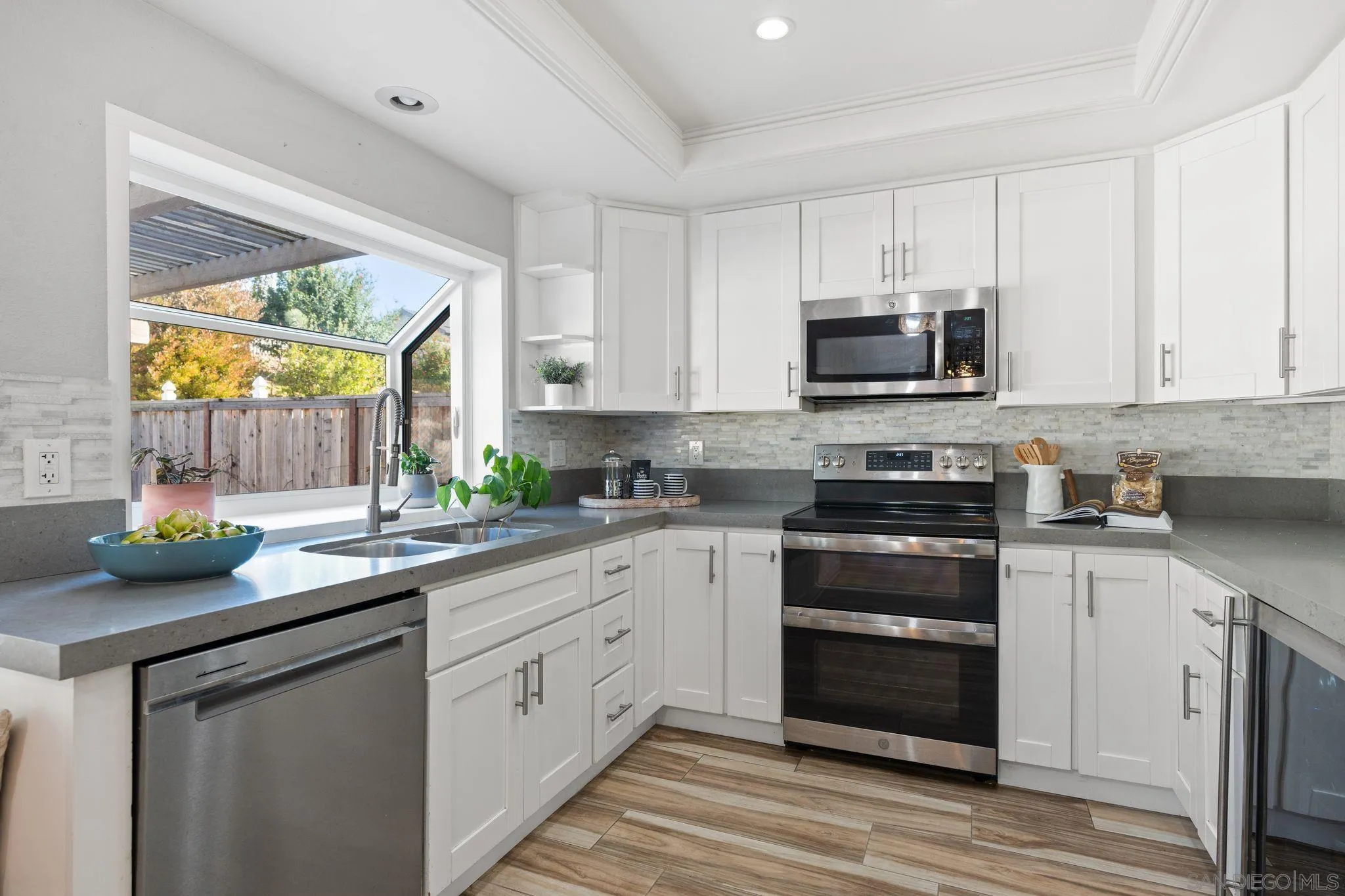 3576 Normandy Circle Oceanside, CA 92056 - Photo 29 of 67 a kitchen with stainless steel appliances a stove sink and microwave