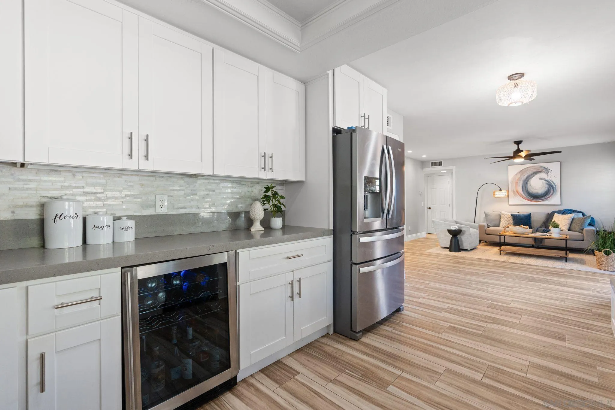 3576 Normandy Circle Oceanside, CA 92056 - Photo 30 of 67 a kitchen with stainless steel appliances granite countertop a refrigerator a stove and white cabinets with wooden floor