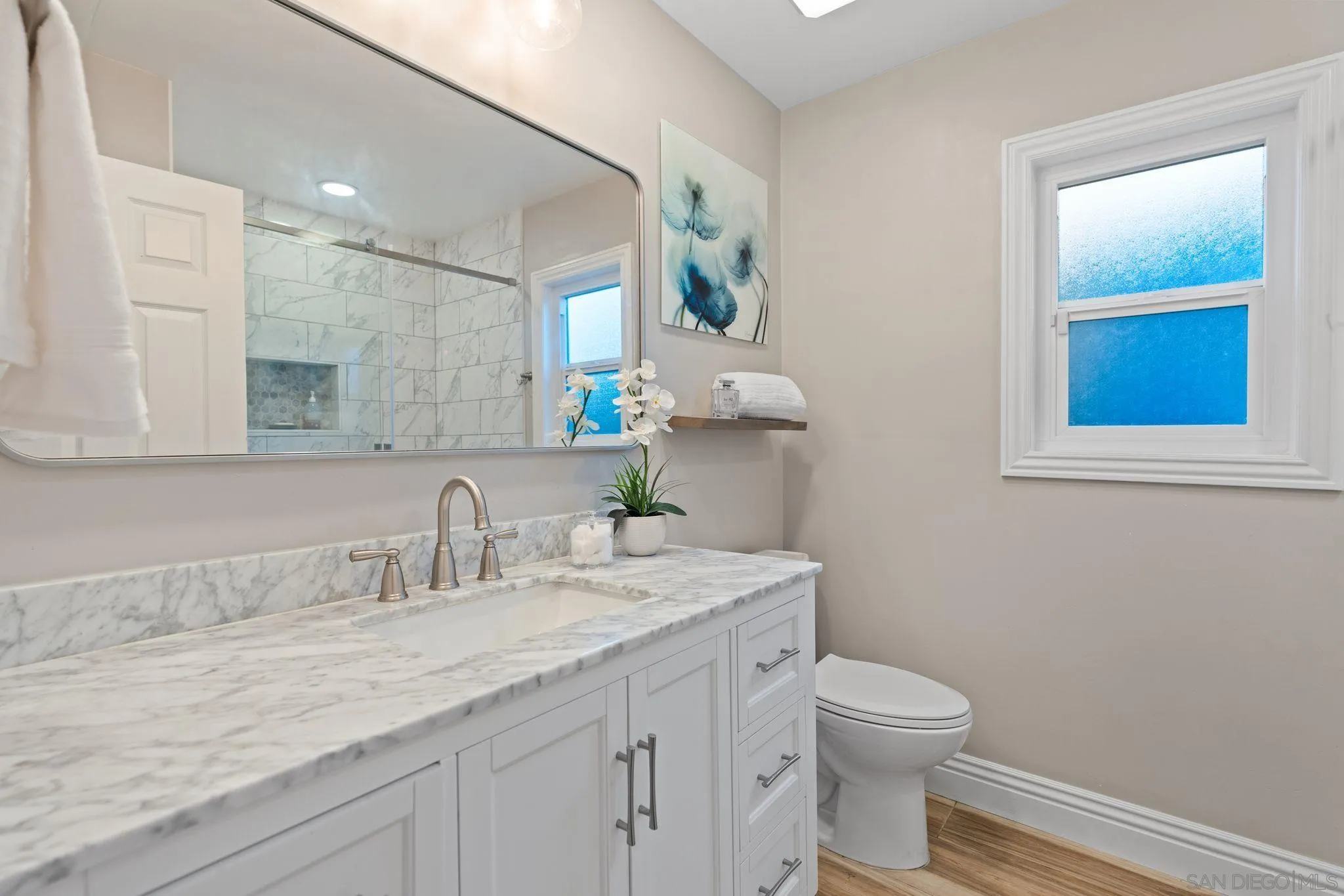 3576 Normandy Circle Oceanside, CA 92056 - Photo 35 of 67 a bathroom with a granite countertop toilet sink and mirror