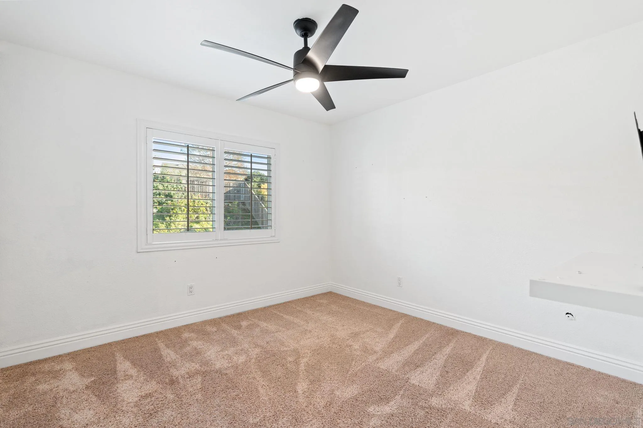 3576 Normandy Circle Oceanside, CA 92056 - Photo 43 of 67 an empty room with a window and a fan