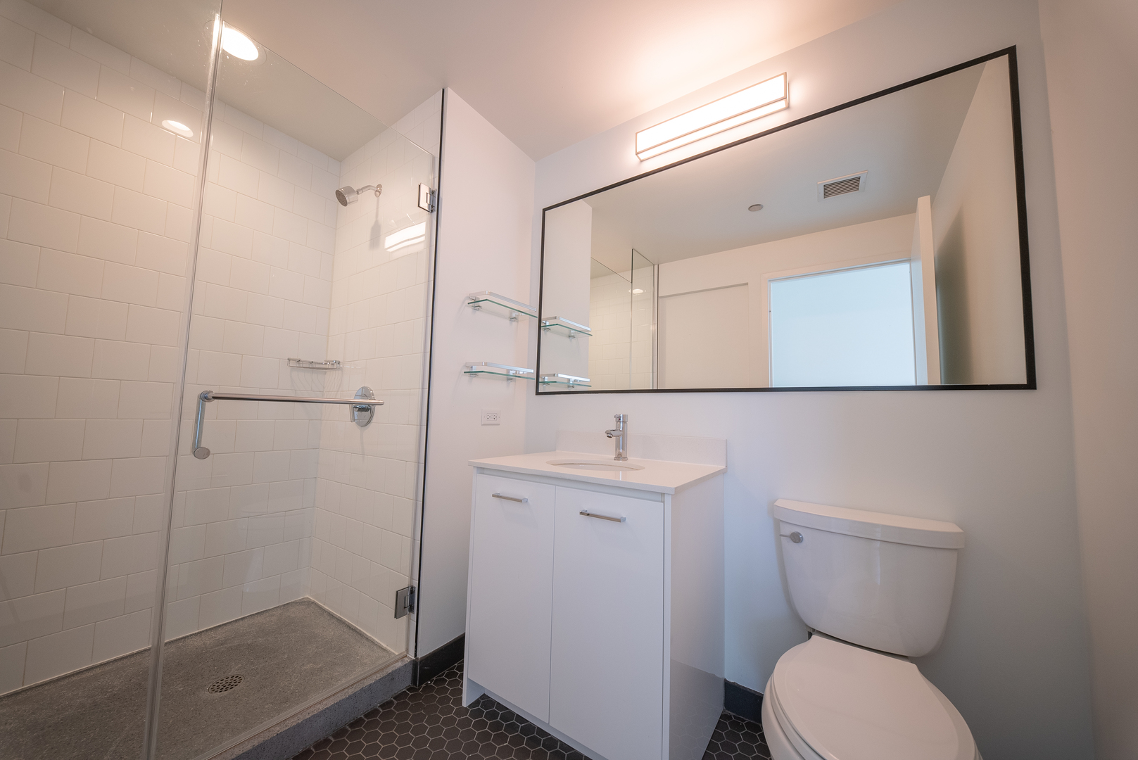 1035 West Van Buren Street, Unit 1900 Chicago, IL 60607 - Photo 8 of 12 a bathroom with a toilet a sink and shower