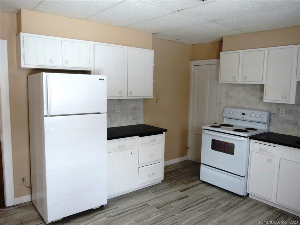 13 Wilcox Street Wethersfield, CT 06109 - Photo 14 of 21 a kitchen with a white cabinets and white appliances