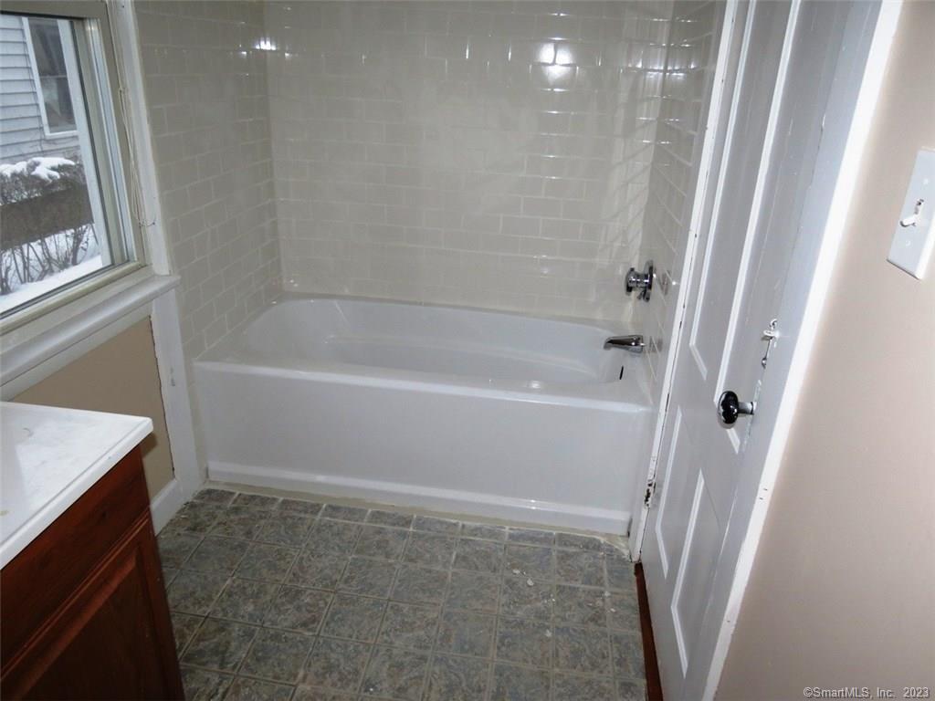 13 Wilcox Street Wethersfield, CT 06109 - Photo 20 of 21 a bathroom with a bathtub and a shower