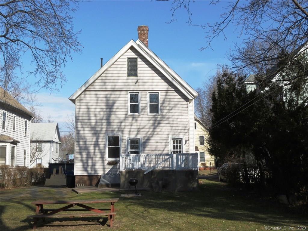13 Wilcox Street Wethersfield, CT 06109 - Photo 2 of 21 a view of a white building among the street with palm trees