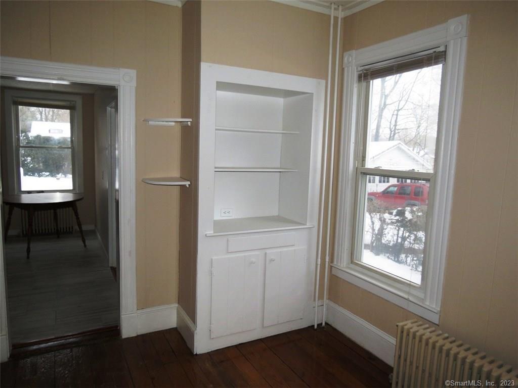 13 Wilcox Street Wethersfield, CT 06109 - Photo 8 of 21 a view of an empty room with wooden floor and a window