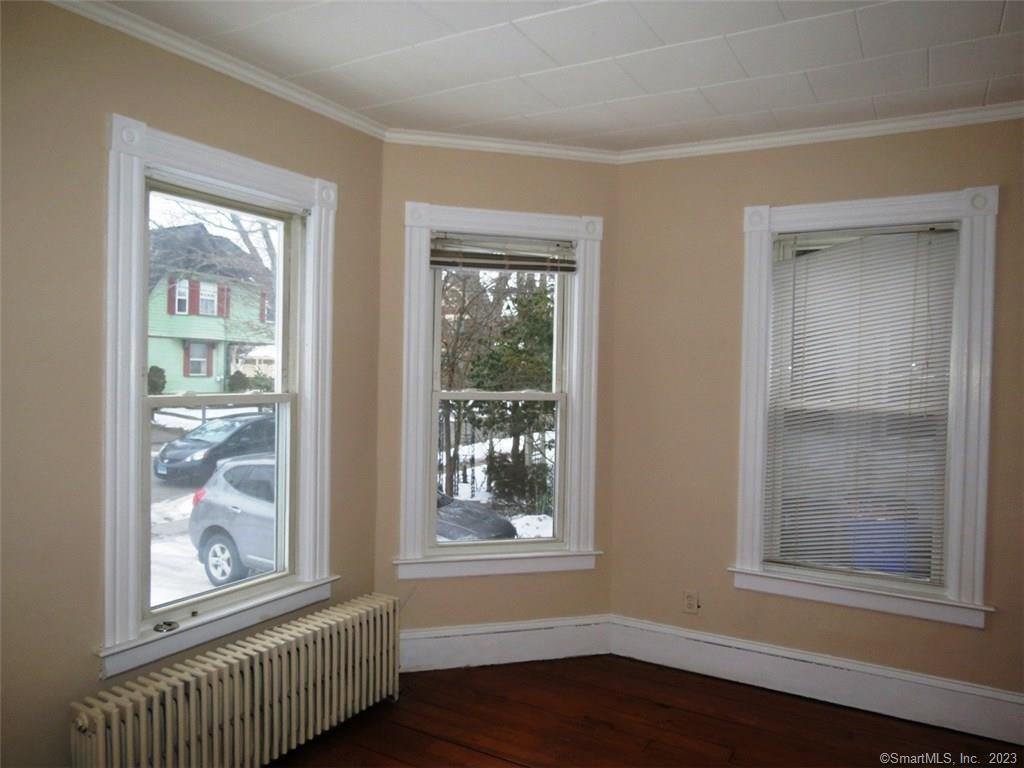 13 Wilcox Street Wethersfield, CT 06109 - Photo 10 of 21 a view of an empty room with wooden floor and a window