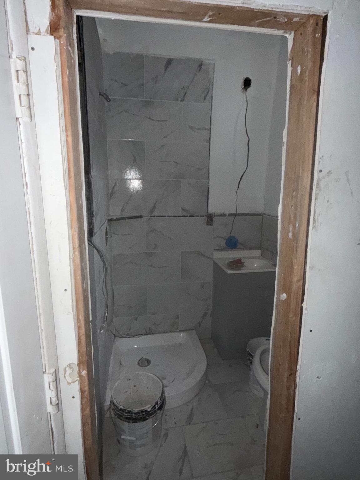 5609 Wyalusing Avenue Philadelphia, PA 19131 - Photo 26 of 36 a bathroom with a granite countertop shower and a toilet