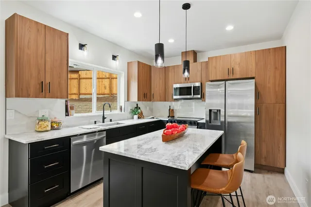 a kitchen with a sink refrigerator and cabinets