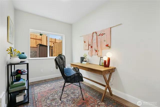 a view of a workspace with furniture and a window