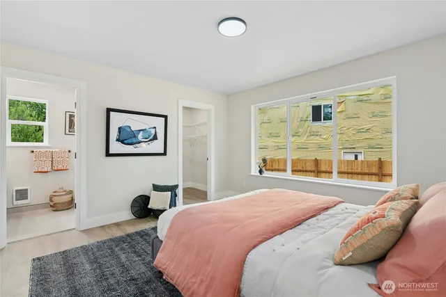 a bedroom with a bed and a large window