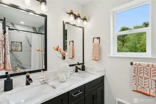 a bathroom with a double vanity sink and a mirror