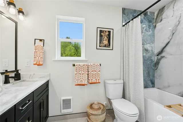 a bathroom with a granite countertop toilet a sink and a bathtub