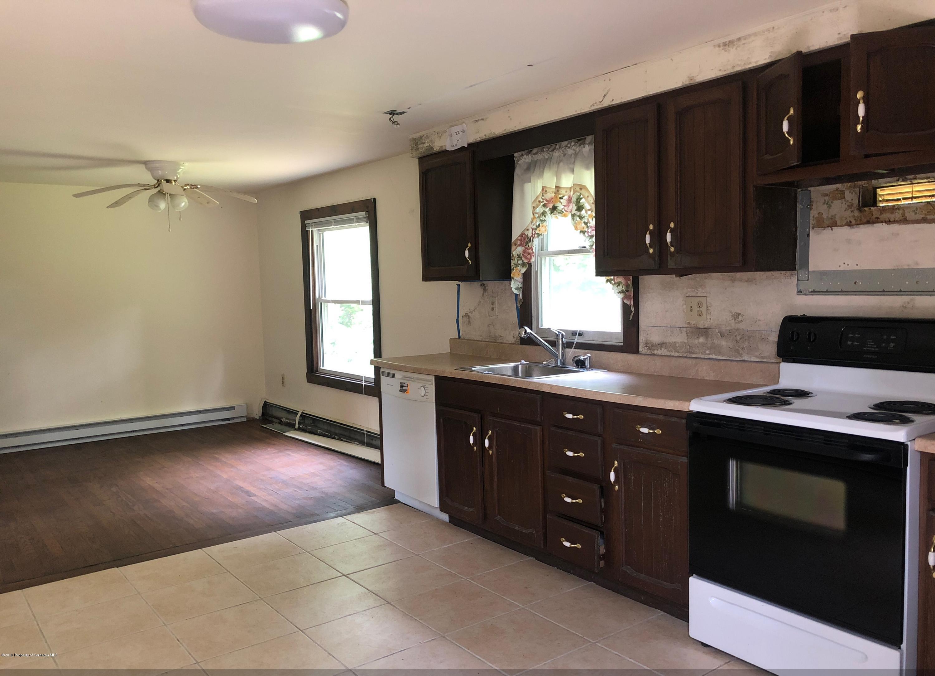 285 Log Rd Lake Lake Ariel, PA 18436 - Photo 3 of 12 a kitchen with a sink stove and cabinets