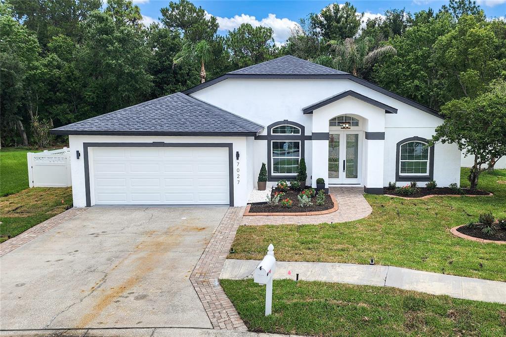 7027 Frascati Loop Wesley Chapel, FL 33544 - Photo 22 of 28 a front view of a house with a yard