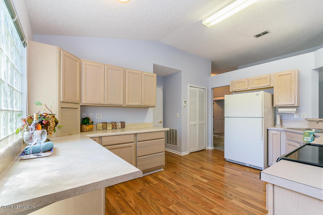 5491 Spring Brook Road Jacksonville, FL 32277 - Photo 4 of 29 a kitchen with a refrigerator and a sink