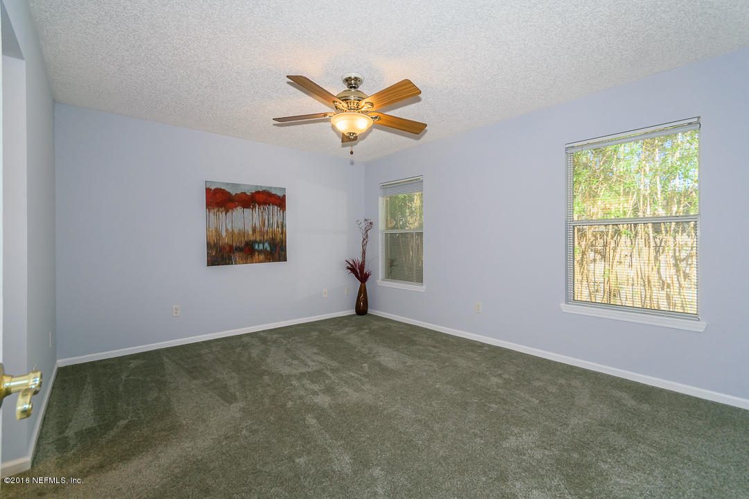 5491 Spring Brook Road Jacksonville, FL 32277 - Photo 8 of 29 an empty room with windows and fan