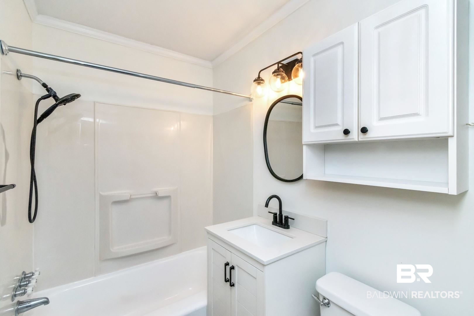 208 Morgan Avenue Mobile, AL 36606 - Photo 15 of 27 Full bathroom with crown molding, vanity, toilet, and bathing tub / shower combination