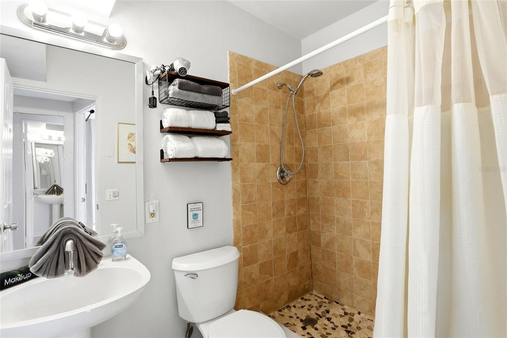 2311 Bay Boulevard Indian Rocks Beach, FL 33785 - Photo 54 of 80 a bathroom with a sink a toilet and shower