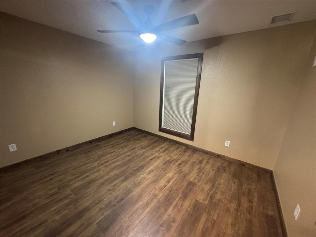 377 Private Road 3249, Unit ARENA Decatur, TX 76234 - Photo 32 of 40 an empty room with wooden floor and windows