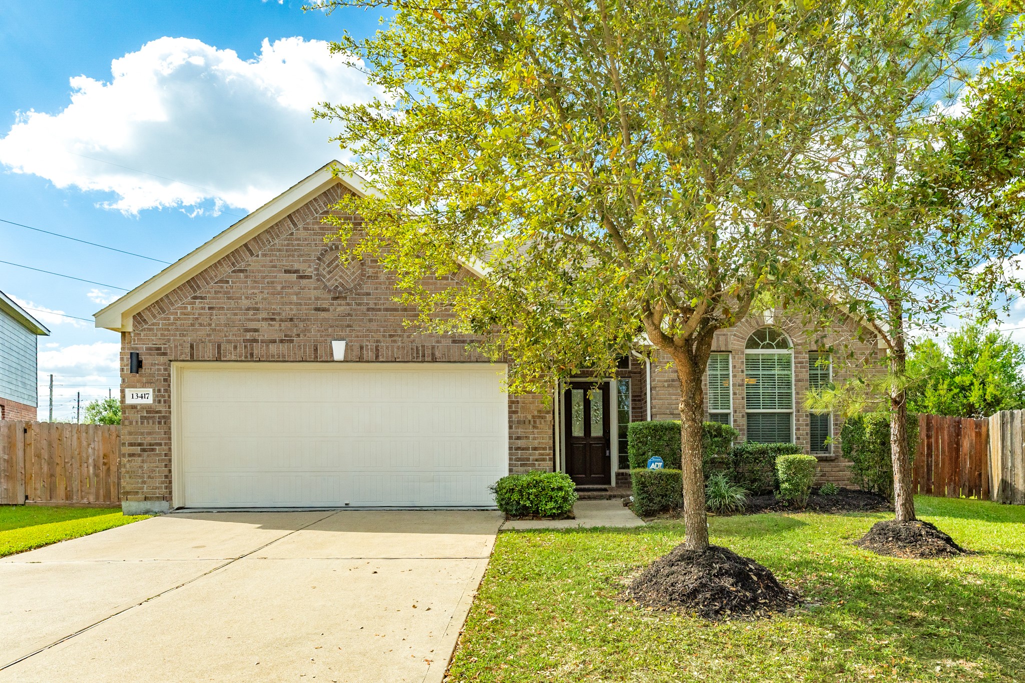 a view of backyard of house with green space