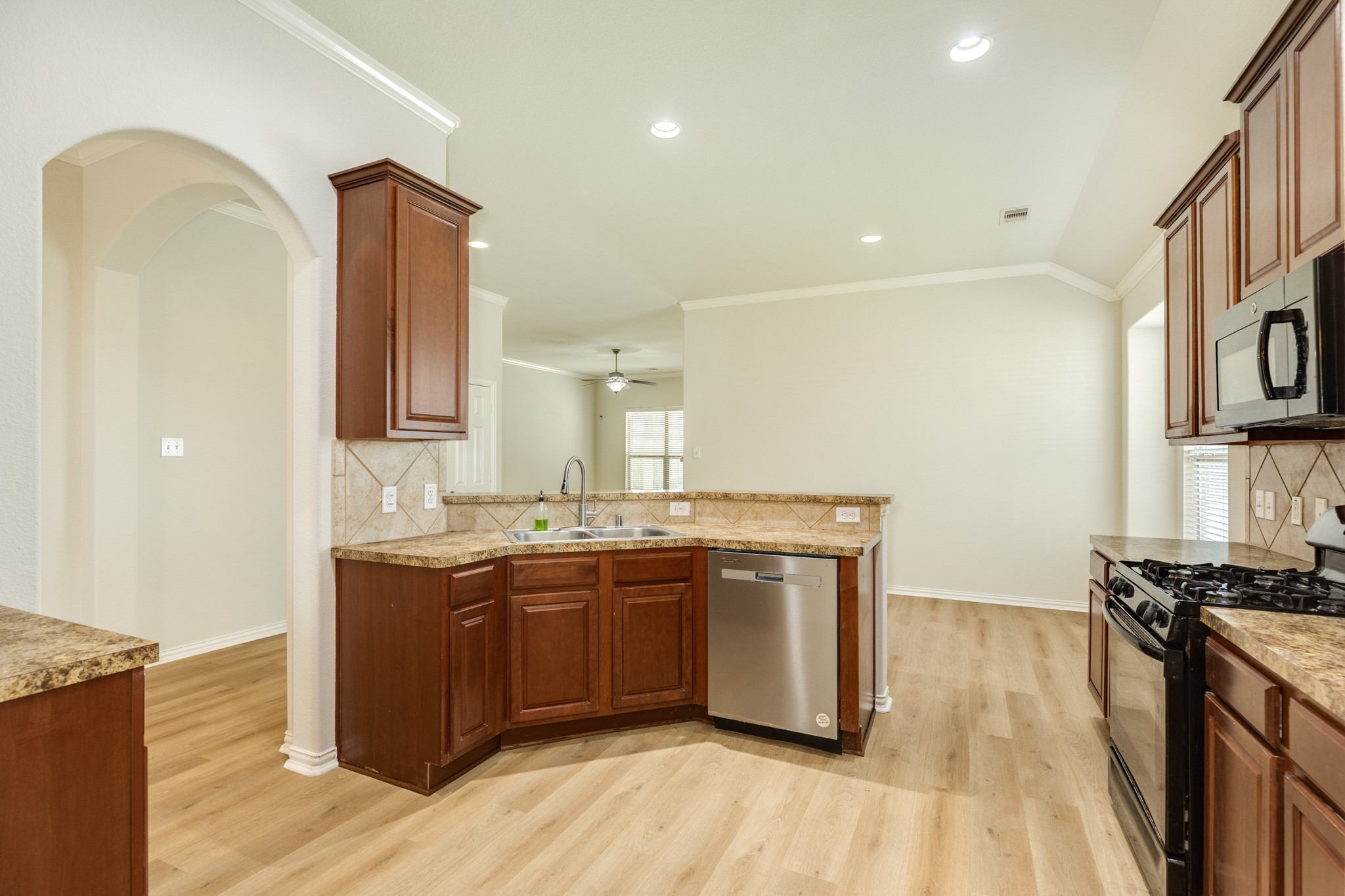 13417 Star Creek Lane Rosharon, TX 77583 - Photo 8 of 41 a kitchen with stainless steel appliances granite countertop a sink stove and wooden floor