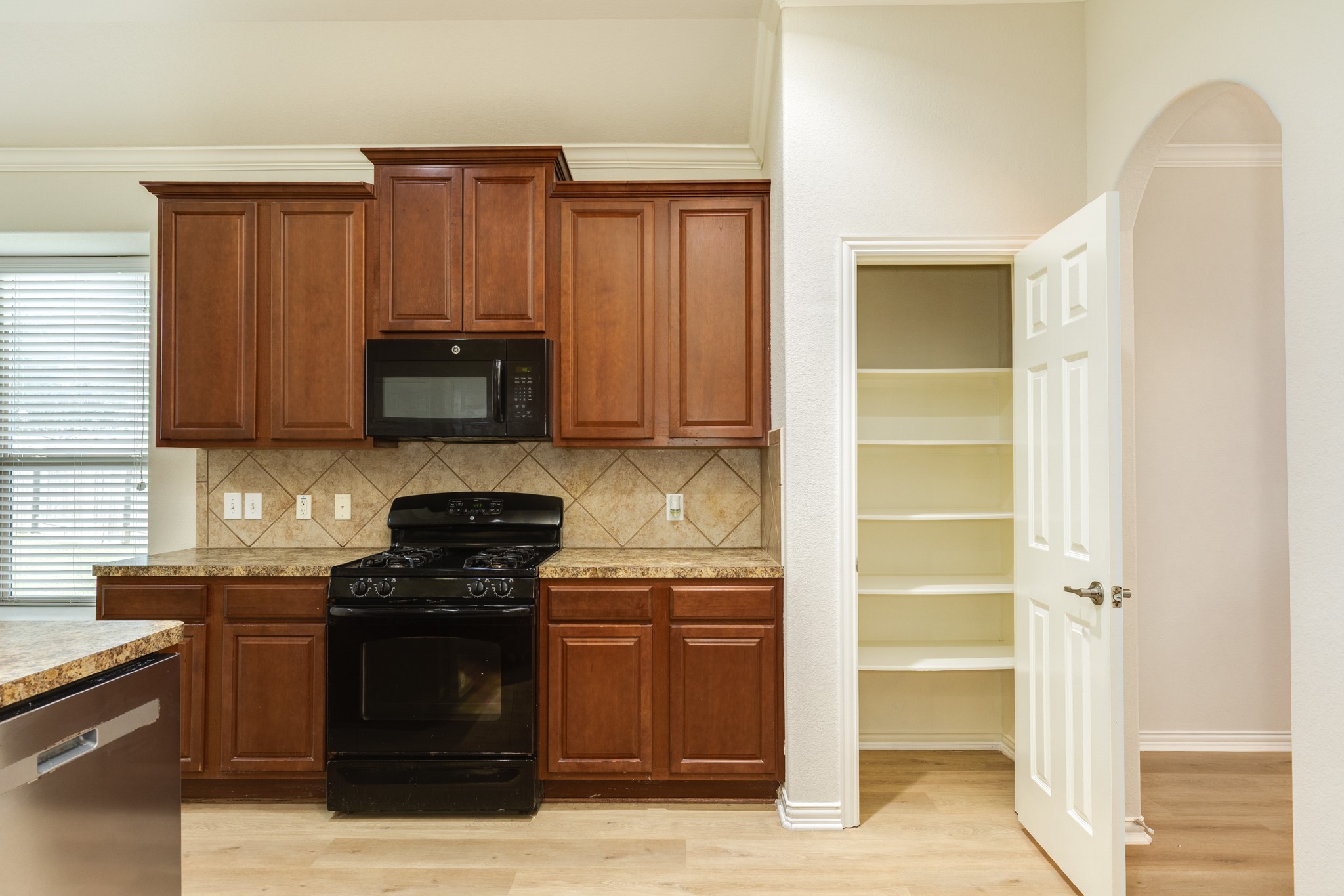 13417 Star Creek Lane Rosharon, TX 77583 - Photo 10 of 41 a kitchen with stainless steel appliances granite countertop a stove and a refrigerator with wooden cabinets