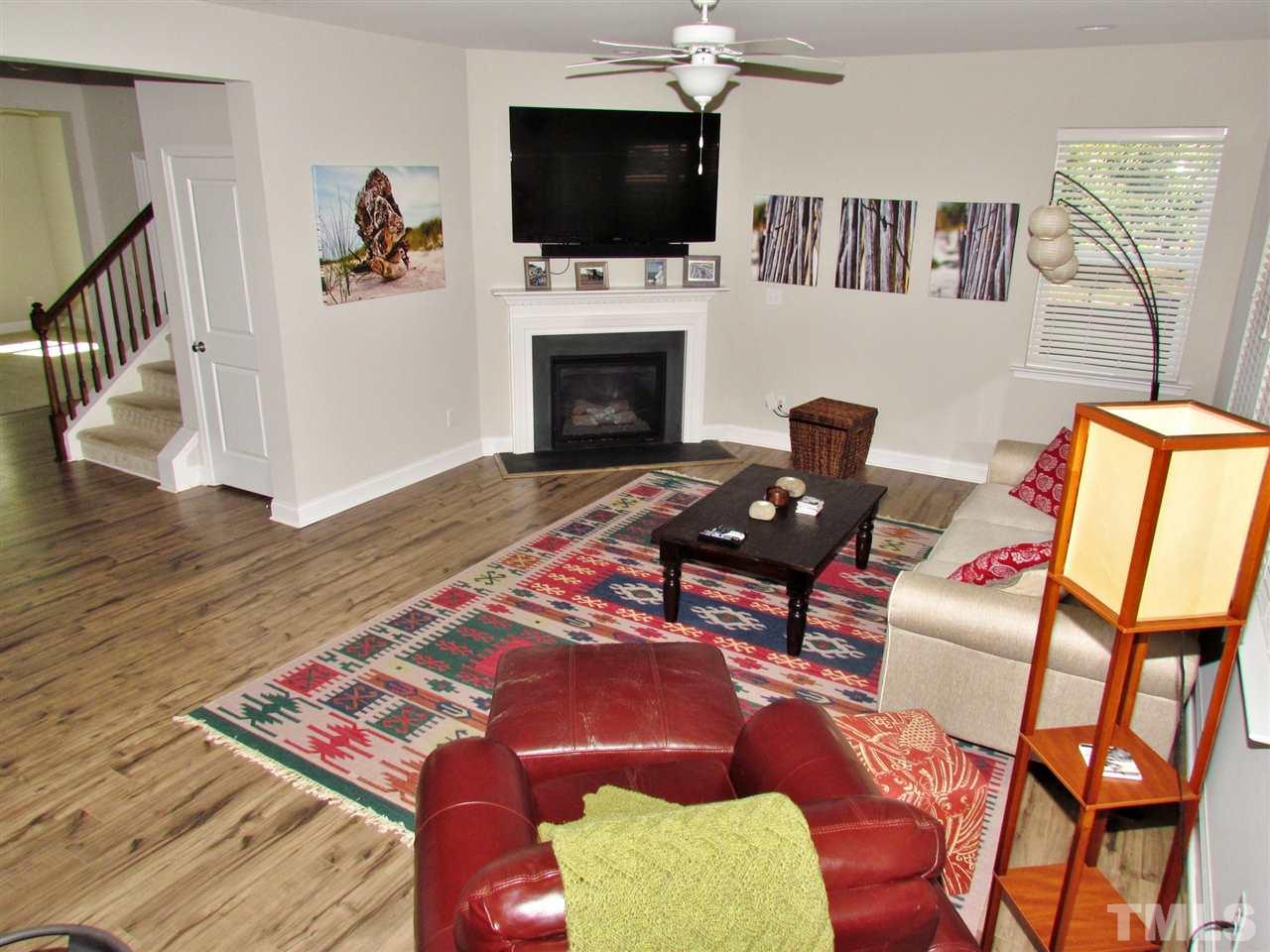 5713 Spring Glen Lane Raleigh, NC 27616 - Photo 4 of 25 a living room with furniture fireplace and flat screen tv