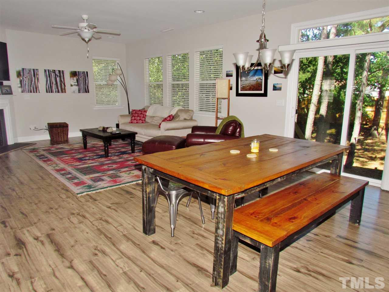 5713 Spring Glen Lane Raleigh, NC 27616 - Photo 5 of 25 a living room with furniture a rug and a large window