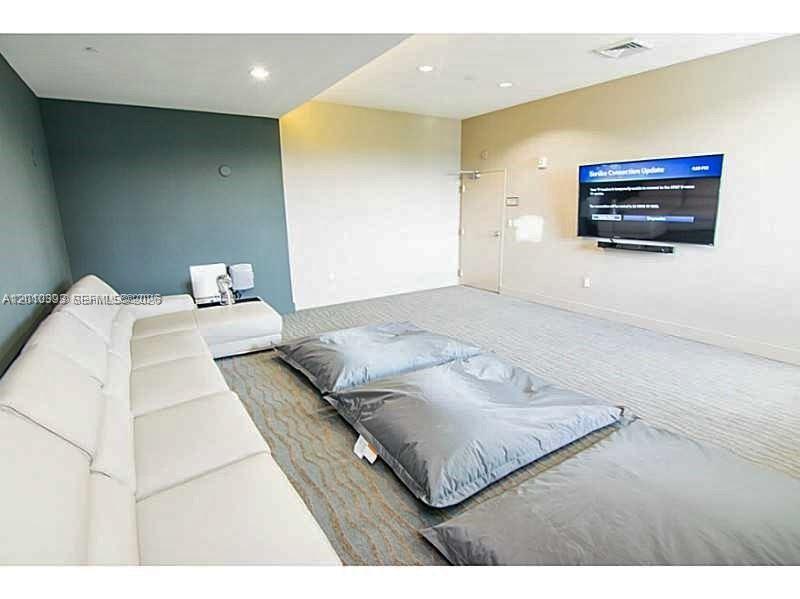 600 Northeast 27th Street, Unit 2001 Miami, FL 33137 - Photo 20 of 20 a bedroom with a bed and a night stand