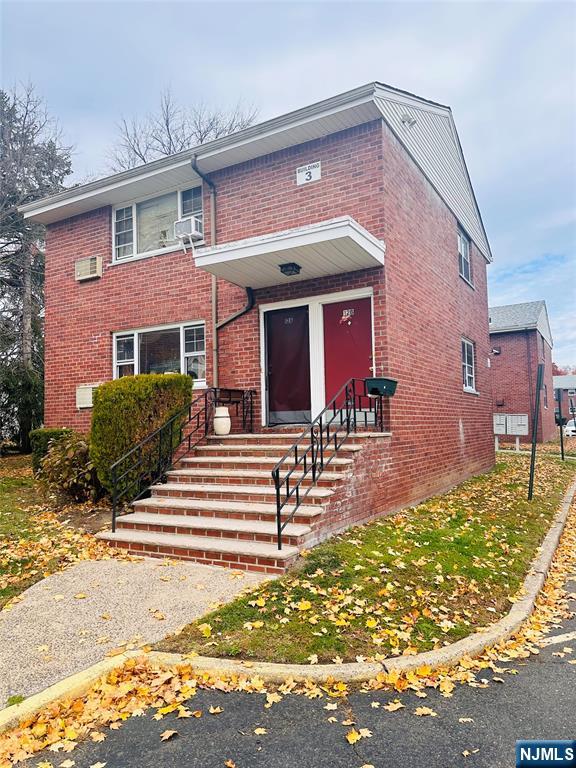 241 West Passaic Street, Unit 12B Rochelle Park, NJ 07662 - Photo 2 of 6 a front view of a house with garden