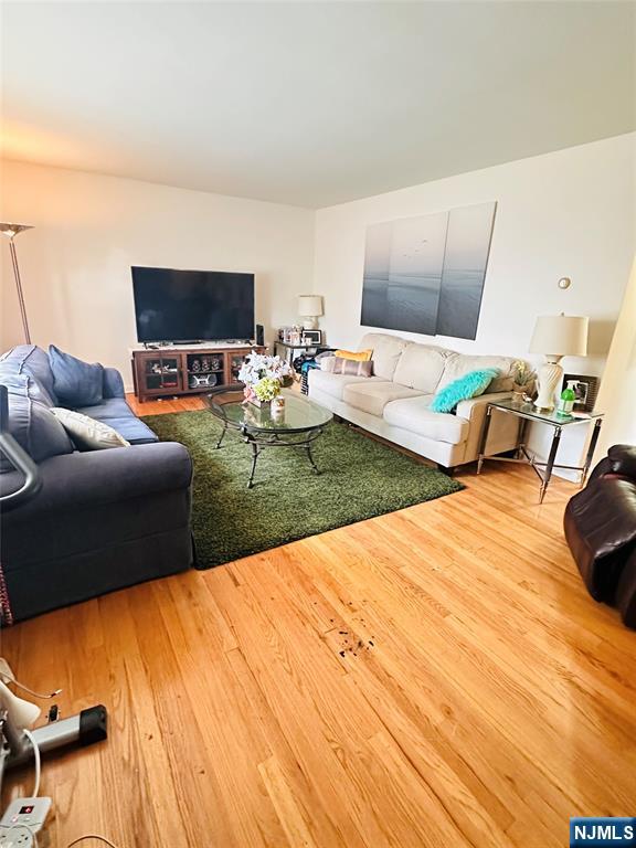 241 West Passaic Street, Unit 12B Rochelle Park, NJ 07662 - Photo 4 of 6 a living room with furniture and a flat screen tv