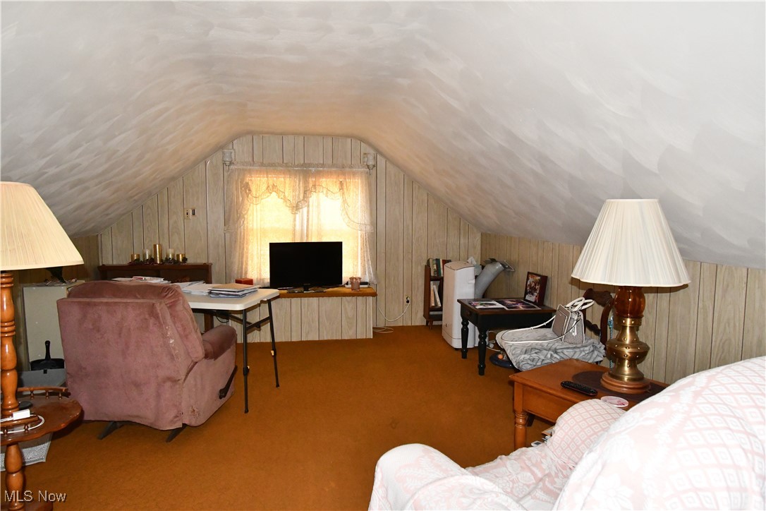 4659 Canfield Road Canfield, OH 44406 - Photo 28 of 34 Bedroom with wood walls, carpet flooring, and vaulted ceiling