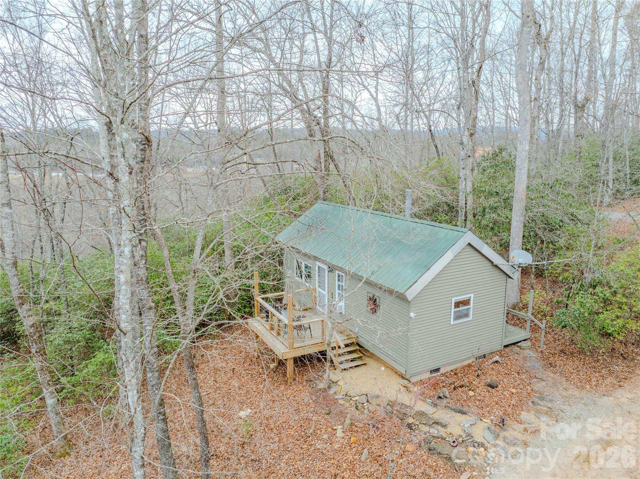 11614 East Fork Road Brevard, NC 28712 - Photo 3 of 3 a roof deck with table and chairs under an umbrella