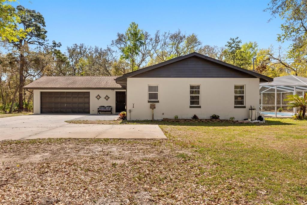 a view of a house with backyard and trees