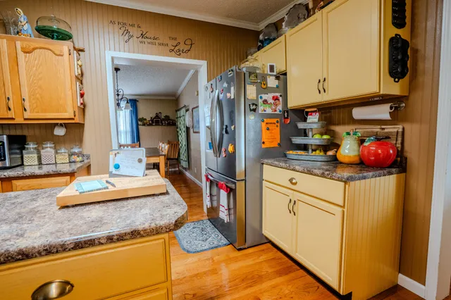 a kitchen with refrigerator and cabinets