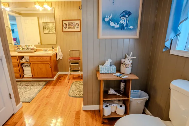 a bathroom with a toilet sink and mirror