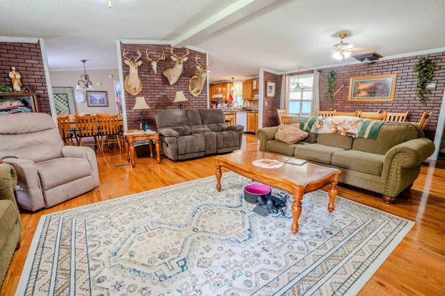 a living room with furniture a rug and a lamp