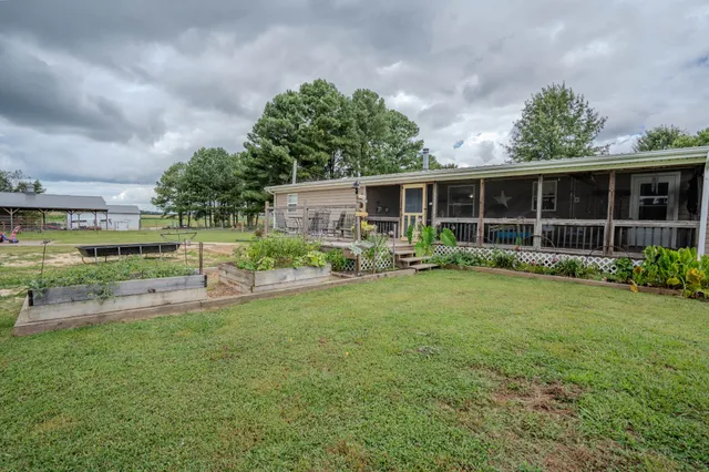a view of a terrace with yard and lake view in back