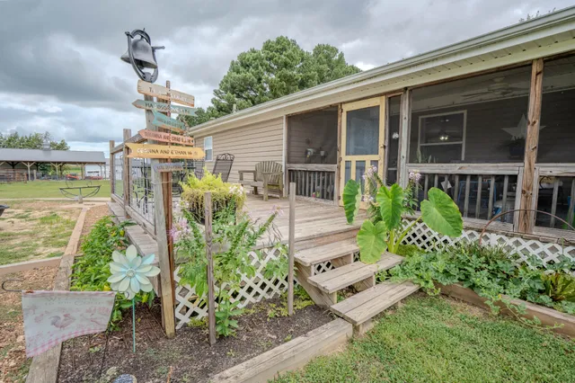 a view of a field with trees in the background