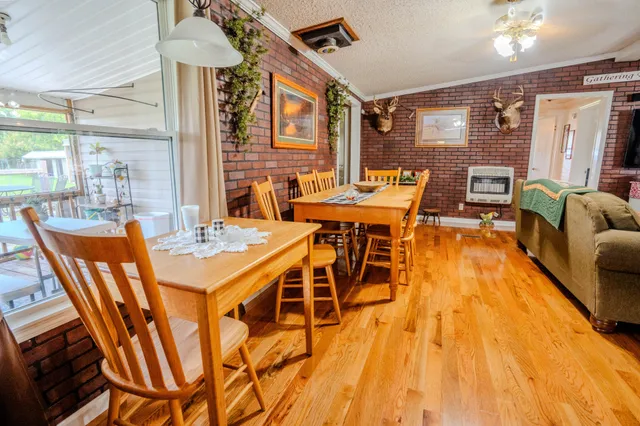 a dining room with furniture and wooden floor