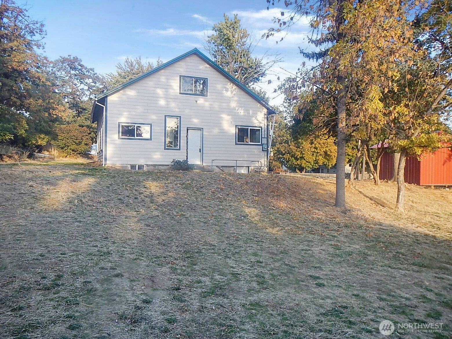 611 North Front Street Dayton, WA 99328 - Photo 5 of 32 a front view of a house with a yard
