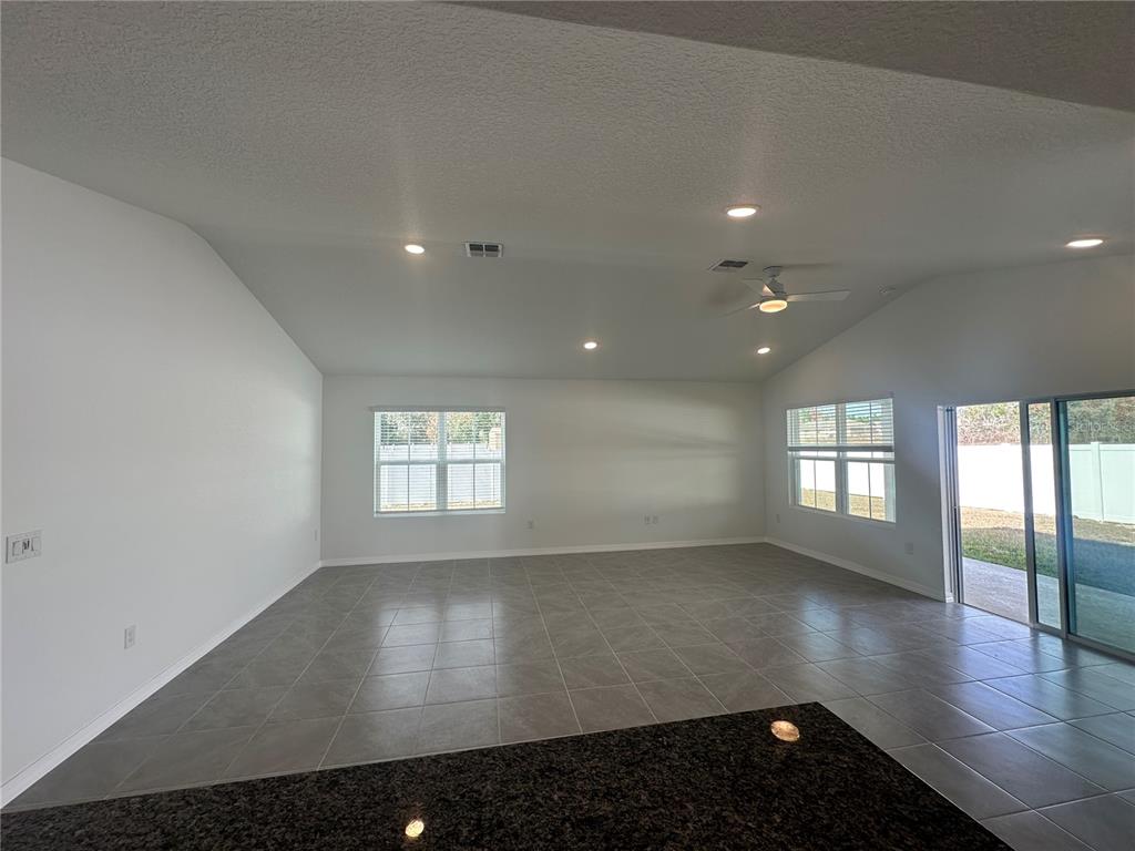 8795 Southwest 135th Place Ocala, FL 34473 - Photo 14 of 22 an empty room with wooden floor and windows