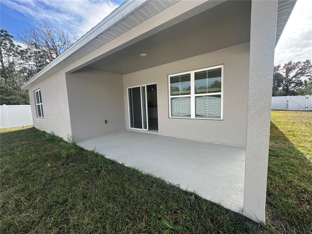 8795 Southwest 135th Place Ocala, FL 34473 - Photo 21 of 22 a view of an house with backyard and windows