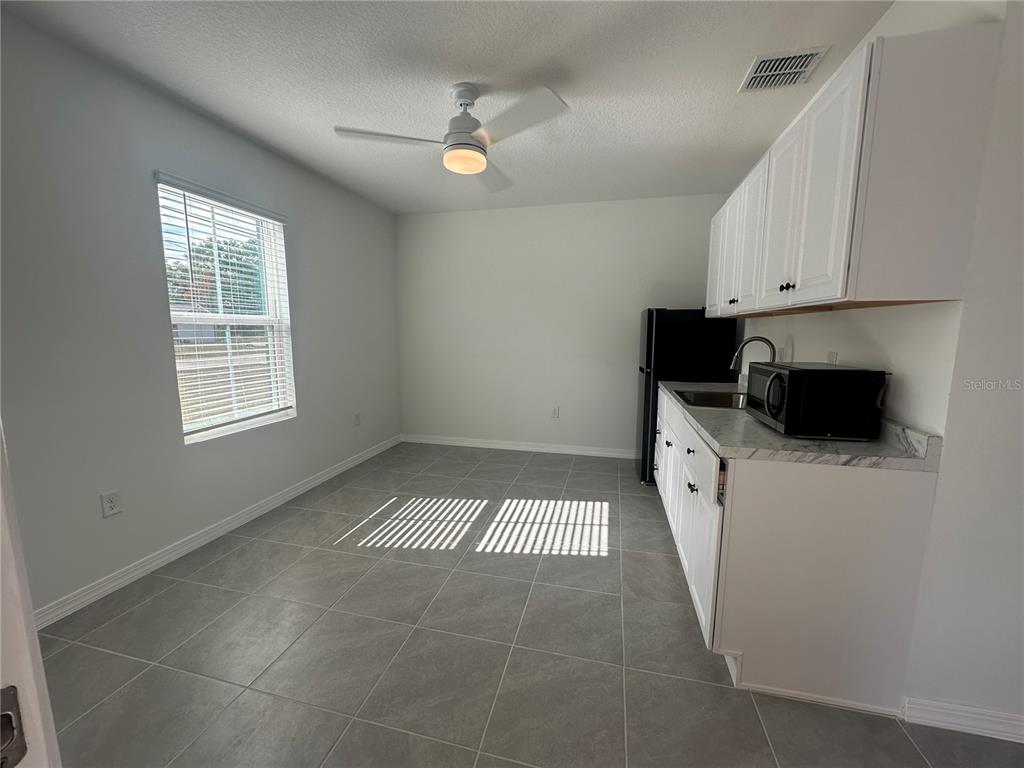 8795 Southwest 135th Place Ocala, FL 34473 - Photo 3 of 22 a view of a kitchen with a sink dishwasher and a microwave oven