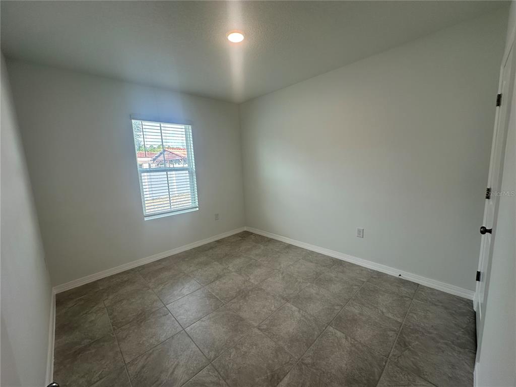 8795 Southwest 135th Place Ocala, FL 34473 - Photo 7 of 22 an empty room with a window