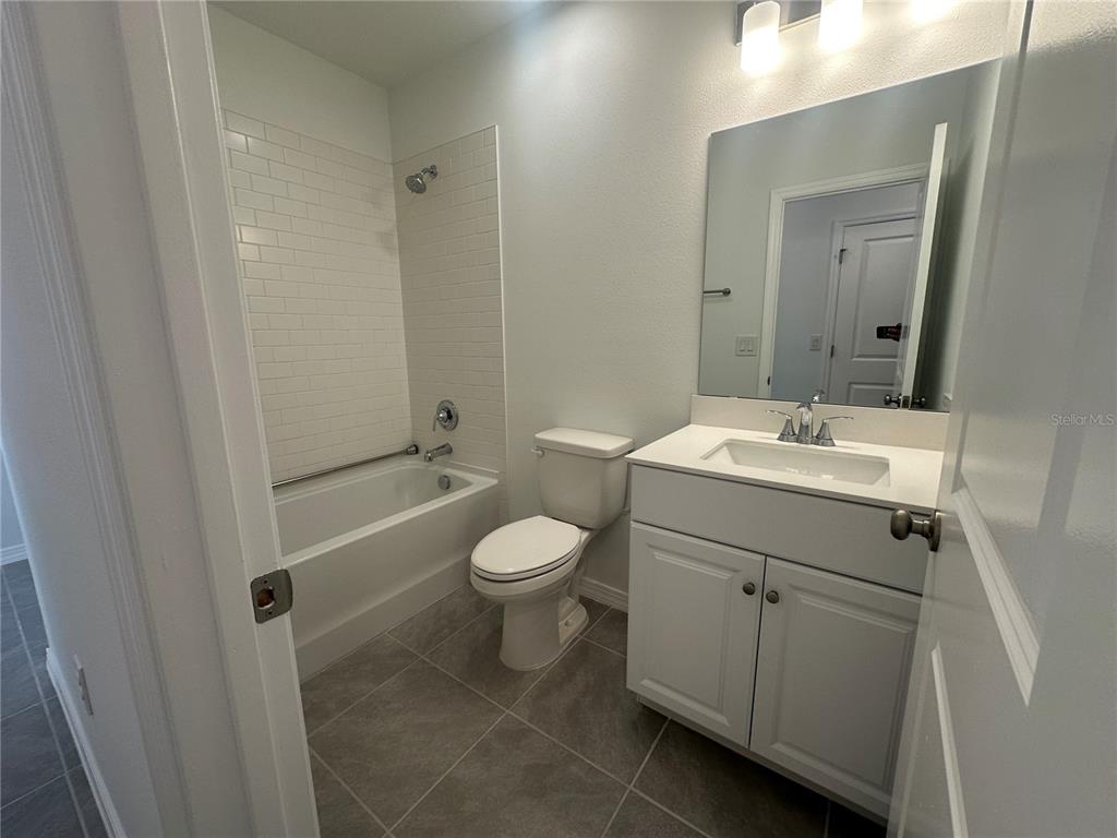 8795 Southwest 135th Place Ocala, FL 34473 - Photo 8 of 22 a bathroom with a sink a toilet and shower