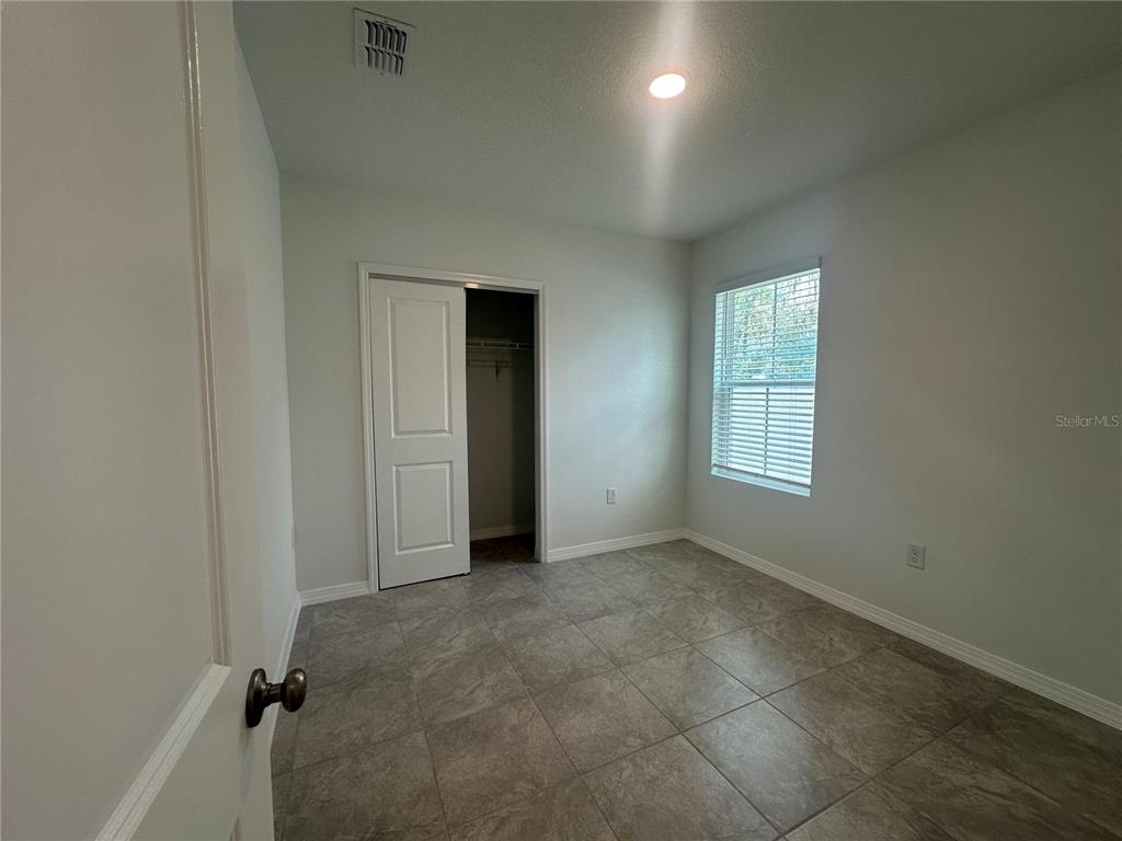 8795 Southwest 135th Place Ocala, FL 34473 - Photo 9 of 22 an empty room with windows and closet