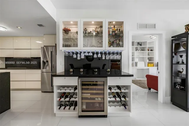 a kitchen with stainless steel appliances a refrigerator and a stove top oven