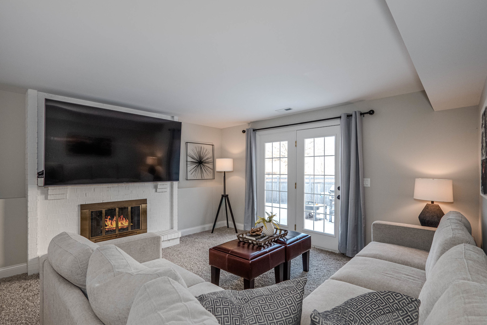 965 Independence Avenue St. Charles, IL 60174 - Photo 19 of 28 a living room with furniture a flat screen tv and a fireplace